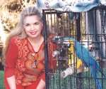 Jean Sasson, avid animal lover, posing with friend Gary Spiveys bird 