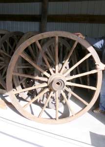 ONE OF THE LARGEST WOODEN WAGON WHEELS I HAVE EVER HAD.