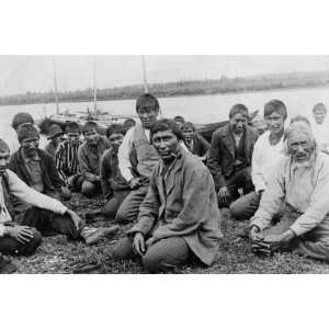   and boys in western dress, seated along shoreline, b